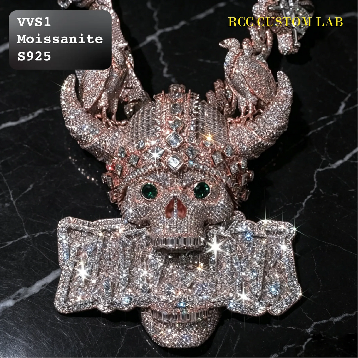 A heavily embellished skull pendant or necklace centerpiece covered in sparkling clear stones, with green gemstone eyes and a rose-gold-toned metal base, shown on a black marble background. Text overlays read 'VVS1 Moissanite S925' and 'RCC CUSTOM LAB'.