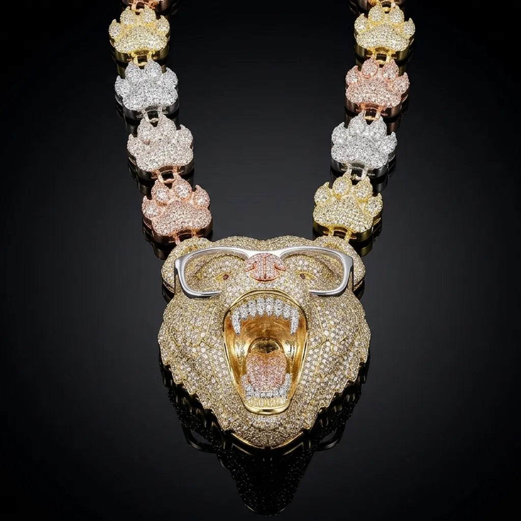 A luxury three-tone yellow gold necklace featuring a large roaring lion head pendant encrusted with diamonds, with matching lion head links forming the chain, displayed on a reflective black background.