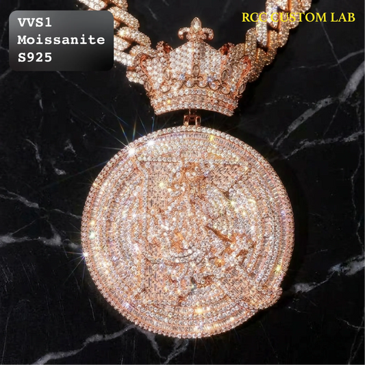 A heavily embellished circular pendant necklace with a matching crown, covered in sparkling clear stones and set in a rose-gold-toned metal, displayed on a black marble background. Text overlays read 'VVS1 Moissanite S925' and 'RCG CRYSTAL LAB'.