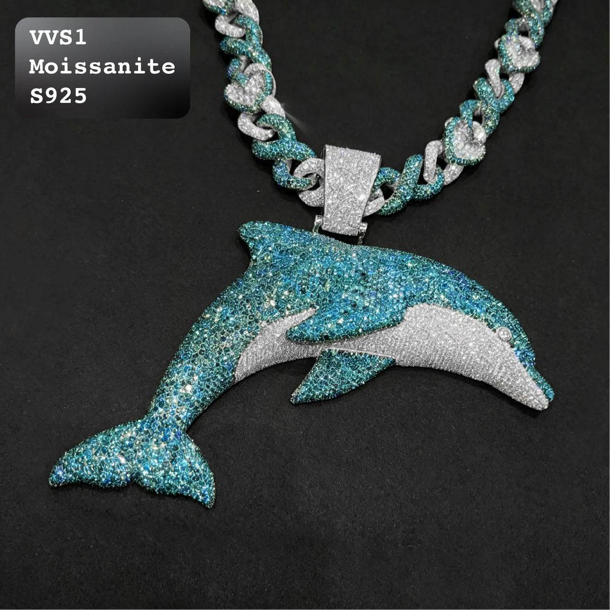 Full view of iced out dolphin pendant with blue and white moissanite setting connected to a matching two tone Cuban link chain in S925 sterling silver.