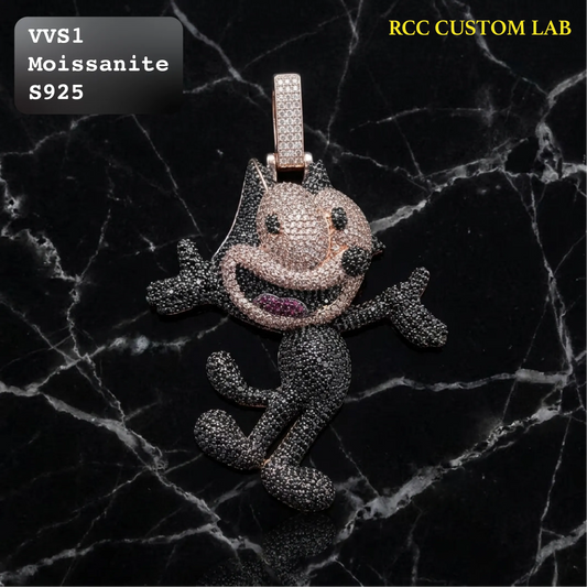 A cartoon character pendant, resembling a smiling dog or cat, covered in sparkling stones. The pendant is displayed on a black marble background with text overlays indicating 'VVS1 Moissanite S925' and 'RCC CUSTOM LAB'.