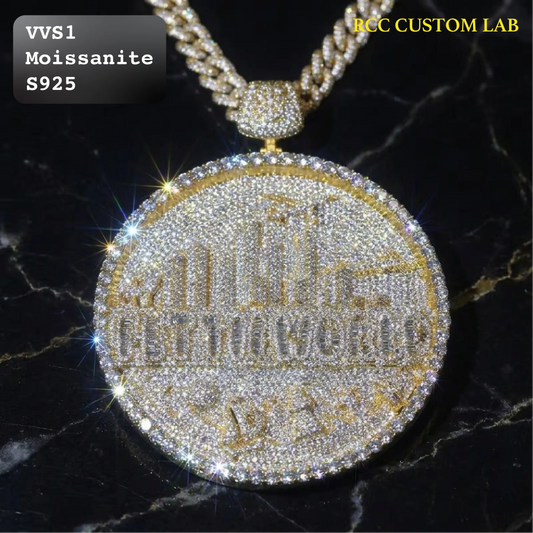 A round gold-tone pendant covered in clear rhinestones, hanging from a gold-tone chain on a black marble background. Text overlays read 'VVS1 Moissanite S925' and 'RCC CUSTOM LAB'.