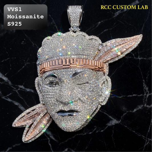 A custom moissanite pendant shaped like a winking face wearing a feathered headdress, set on a black marble background. The pendant features rose gold accents on the headdress band and feather details, with a white diamond-encrusted face and headdress.