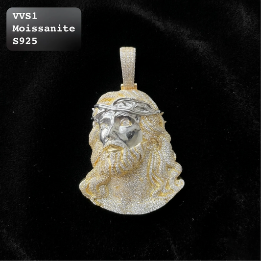 A Jesus bust pendant featuring a silver-tone crown of thorns and face, with gold-tone hair and beard, set against a black velvet background. A text overlay in the top-left corner reads 'VVS1 Moissanite S925'.
