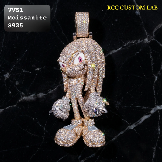 A custom cartoon character pendant, likely inspired by Sonic, heavily paved with gold and clear stones (moissanite) on a black marble background. The pendant features a gold-toned metal base with clear stones covering the entire figure, including the hair, face, hands, and boots.