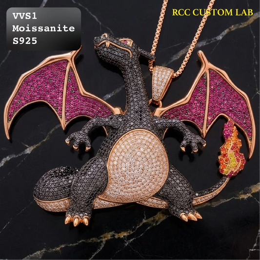 A dragon pendant necklace on a black marble background, featuring a rose gold dragon body and wings paved with dark and pink gemstones, with a small flame accent and a chain. Text overlays read 'VVS1 Moissanite S925' and 'RCC CUSTOM LAB'.