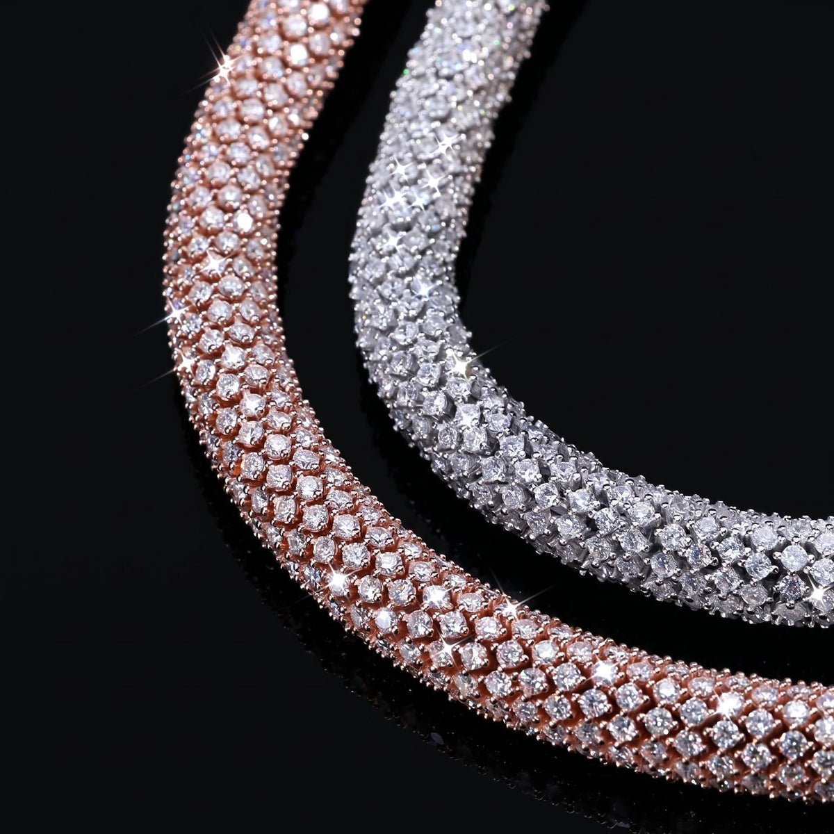 Two pave-set chain necklaces, one in rose gold and one in silver, both covered in small clear stones, displayed on a reflective black surface. Rcc ice authentic product
