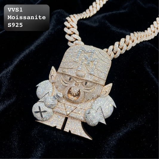 A heavily paved Moissanite character pendant necklace on a thick curb chain, displayed on a black velvet background. The pendant features a cartoonish character with a gold nose and ears, covered in sparkling clear stones.