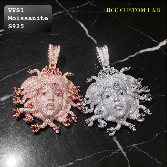 Two Medusa-style pendants with moonburst details, one rose gold and one silver, both heavily set with clear stones. They are displayed on a black marble background with text overlays reading 'VVS1 Moissanite S925' and 'RCC CUSTOM LAB'.