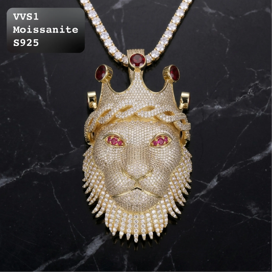 VVS1 moissanite fully iced lion head pendant with crown and ruby red eyes, crafted in S925 sterling silver with gold finish, paired with moissanite tennis chain on black marble background