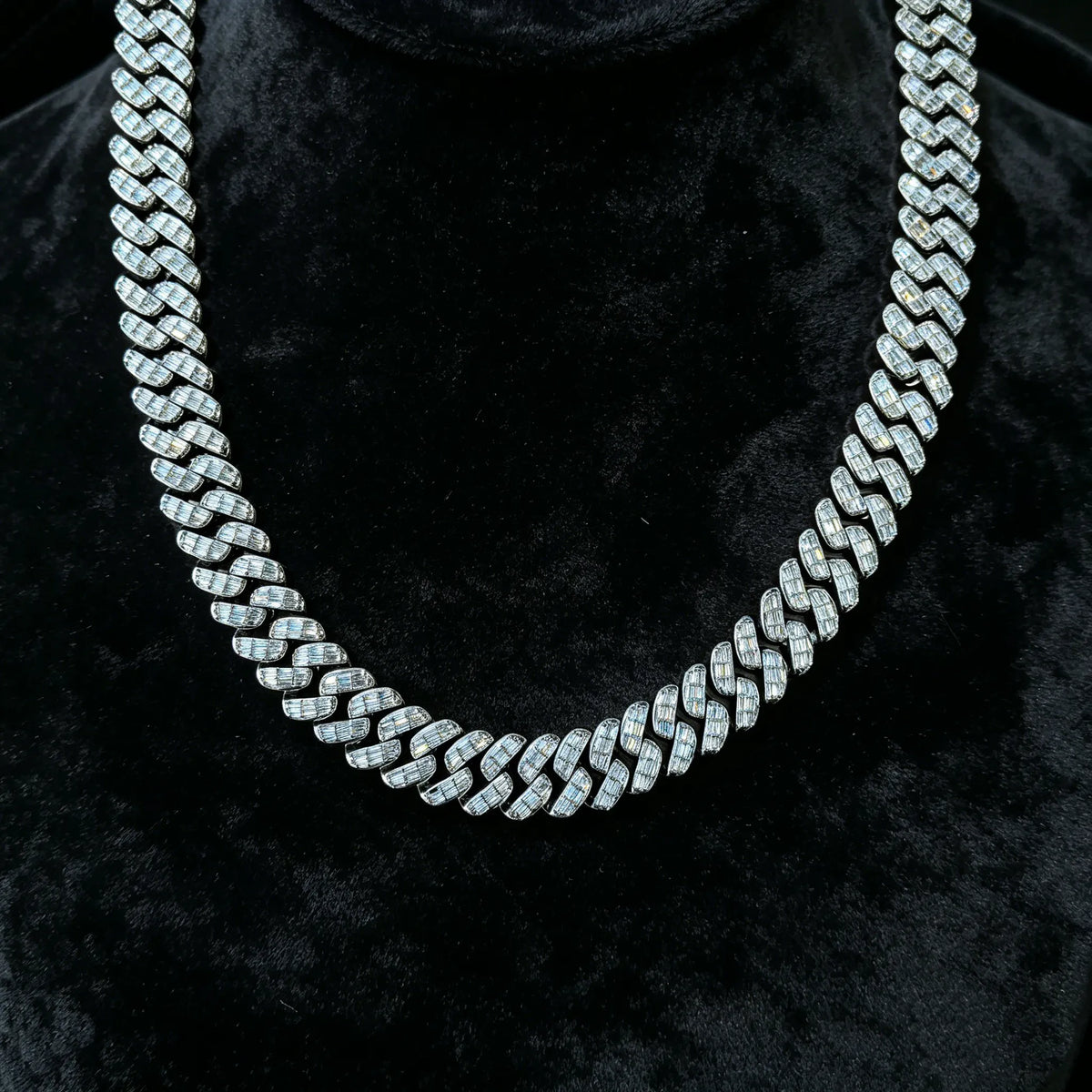 Hanging shot of silver tone baguette moissanite cuban link necklace, every link paved with rectangular stones, premium icy men hip hop chain