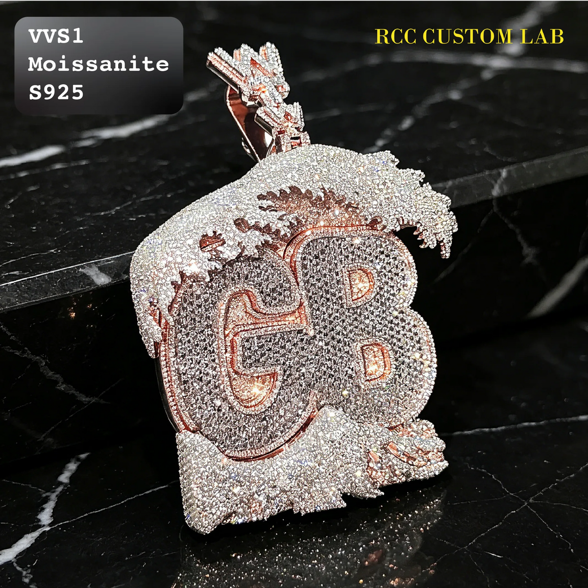 A heavy, diamond-encrusted pendant featuring the letters 'GB' in rose gold over a silver-toned moissanite background, displayed on a black marble surface. Text overlays read 'VVS1 Moissanite S925' and 'RCC CUSTOM LAB'.