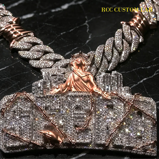 Silver and rose gold two tone fully iced custom pendant with city skyline, robed statue figure and wrapped barbed wire detail, micro pave moissanite hip hop letter jewelry paired with two tone cuban link chain