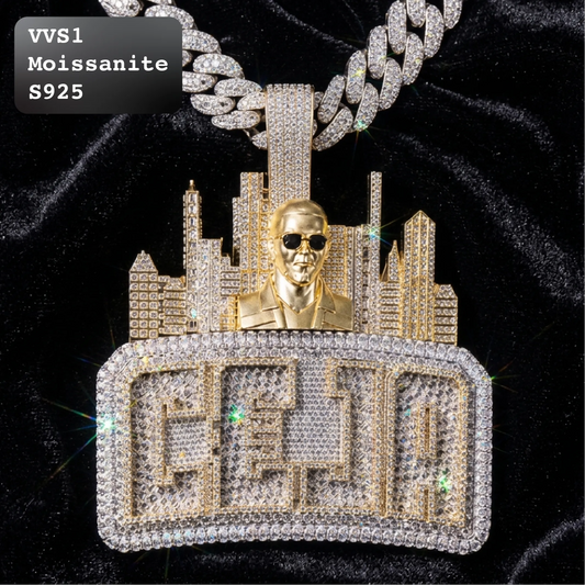 A gold and crystal pendant necklace featuring a city skyline, a gold bust figure wearing sunglasses, and a large rectangular block with stylized lettering, displayed on a black velvet background. A text label in the top-left corner reads 'VVS1 Moissanite S925'.