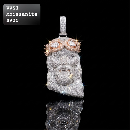 A moissanite Jesus pendant on a black reflective background, featuring a silver-toned face encrusted with clear stones and a rose-gold crown with clear stones. A text overlay in the top-left corner reads 'VVS1 Moissanite S925'.